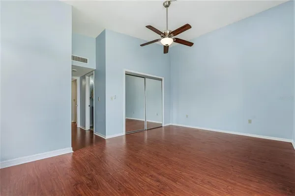 a view of an empty room with wooden floor