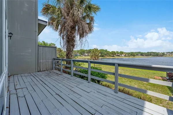 a front view of a house with a garden and trees