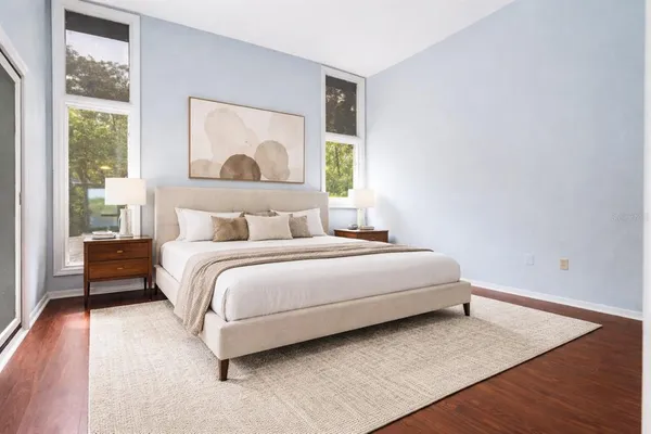 a bedroom with a bed and a large window