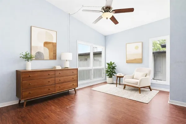 a living room with furniture and wooden floor
