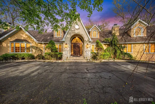 a large kitchen with stainless steel appliances granite countertop a stove top oven a sink and dishwasher