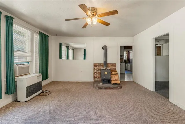 a view of a livingroom with furniture and a ceiling fan