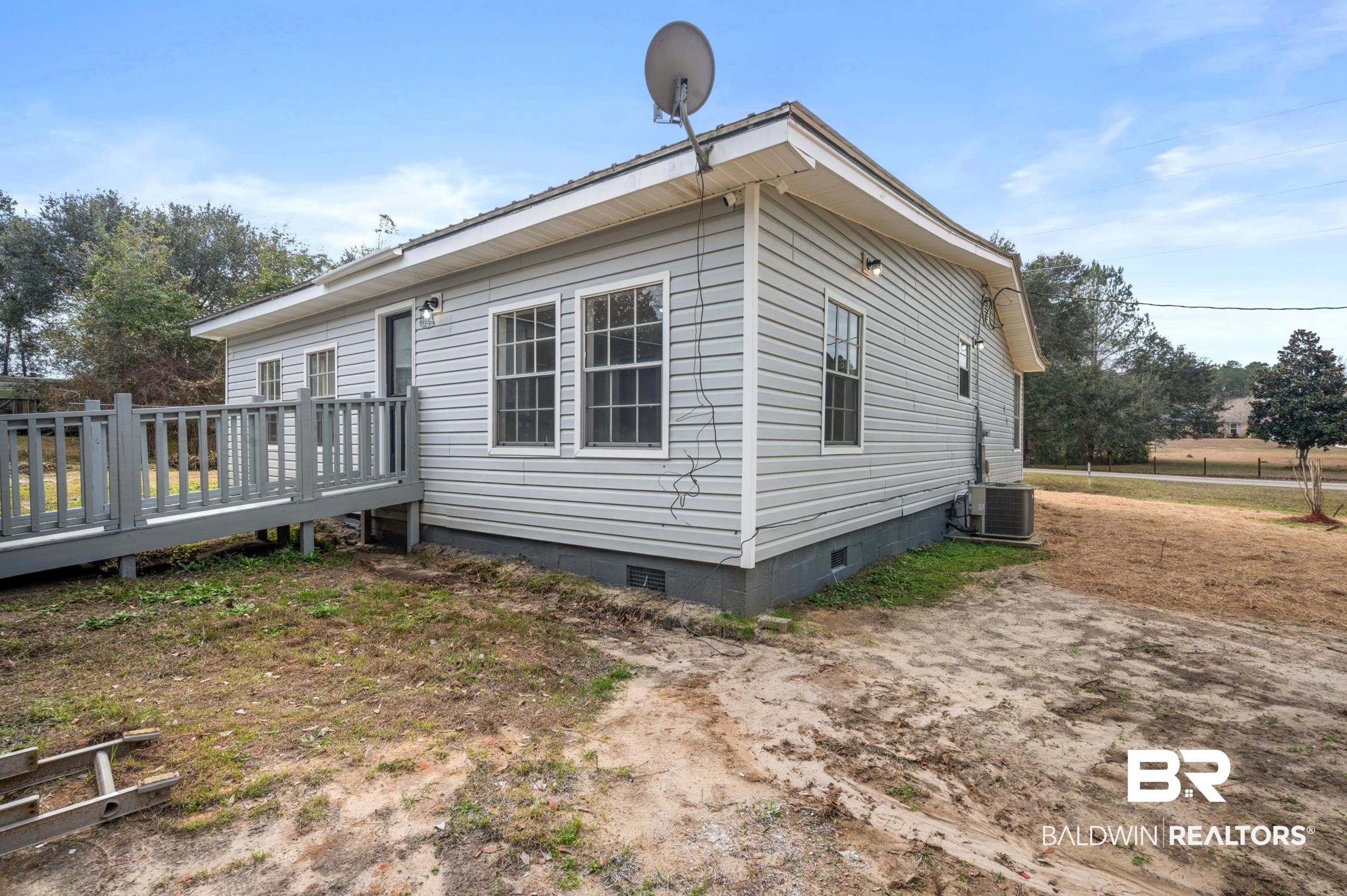 35780 Spring Road North Stapleton, AL 36578 - Photo 40 of 41 View of side of property featuring crawl space and a deck
