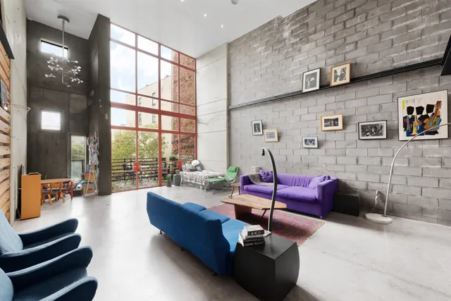 a living room with furniture and large windows