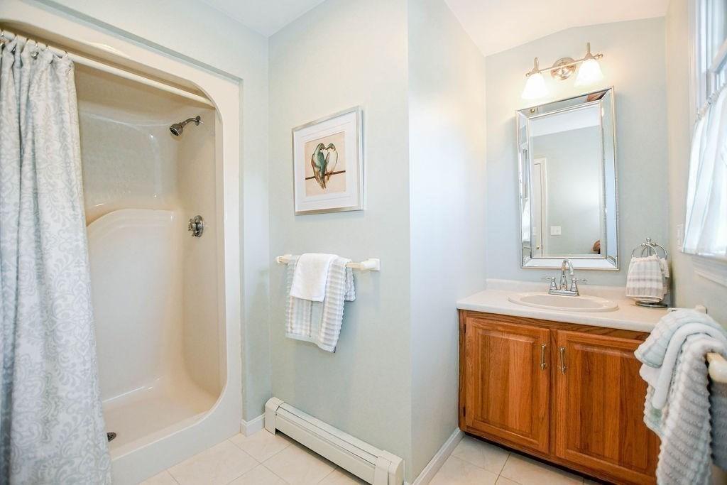 12 Forster Road Rochester, MA 02770 - Photo 28 of 42 a bathroom with a granite countertop sink a mirror and a bathtub