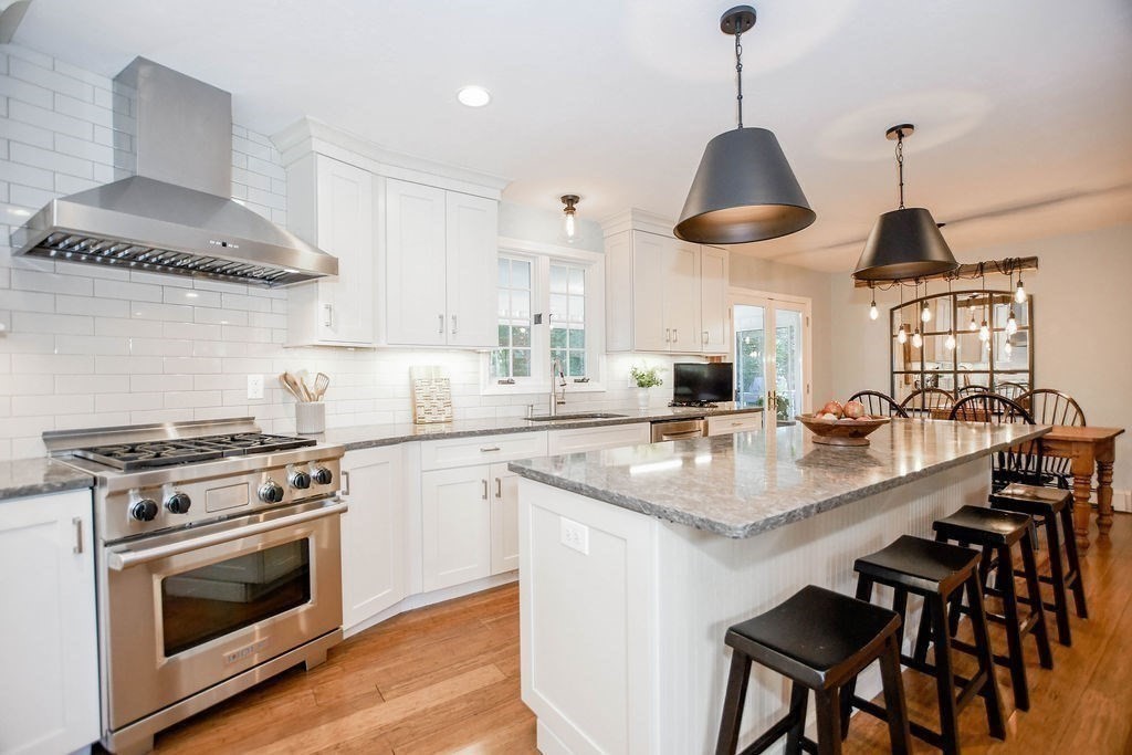 12 Forster Road Rochester, MA 02770 - Photo 3 of 42 a kitchen with stainless steel appliances a stove a sink a dining table and chairs