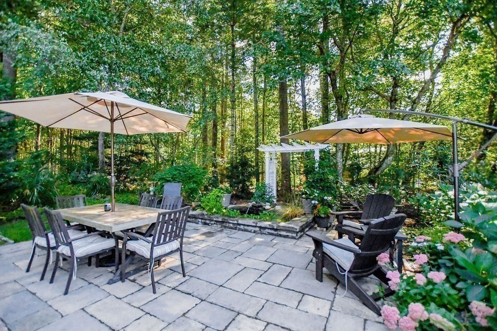 12 Forster Road Rochester, MA 02770 - Photo 32 of 42 a view of a patio with furniture and a table under an umbrella