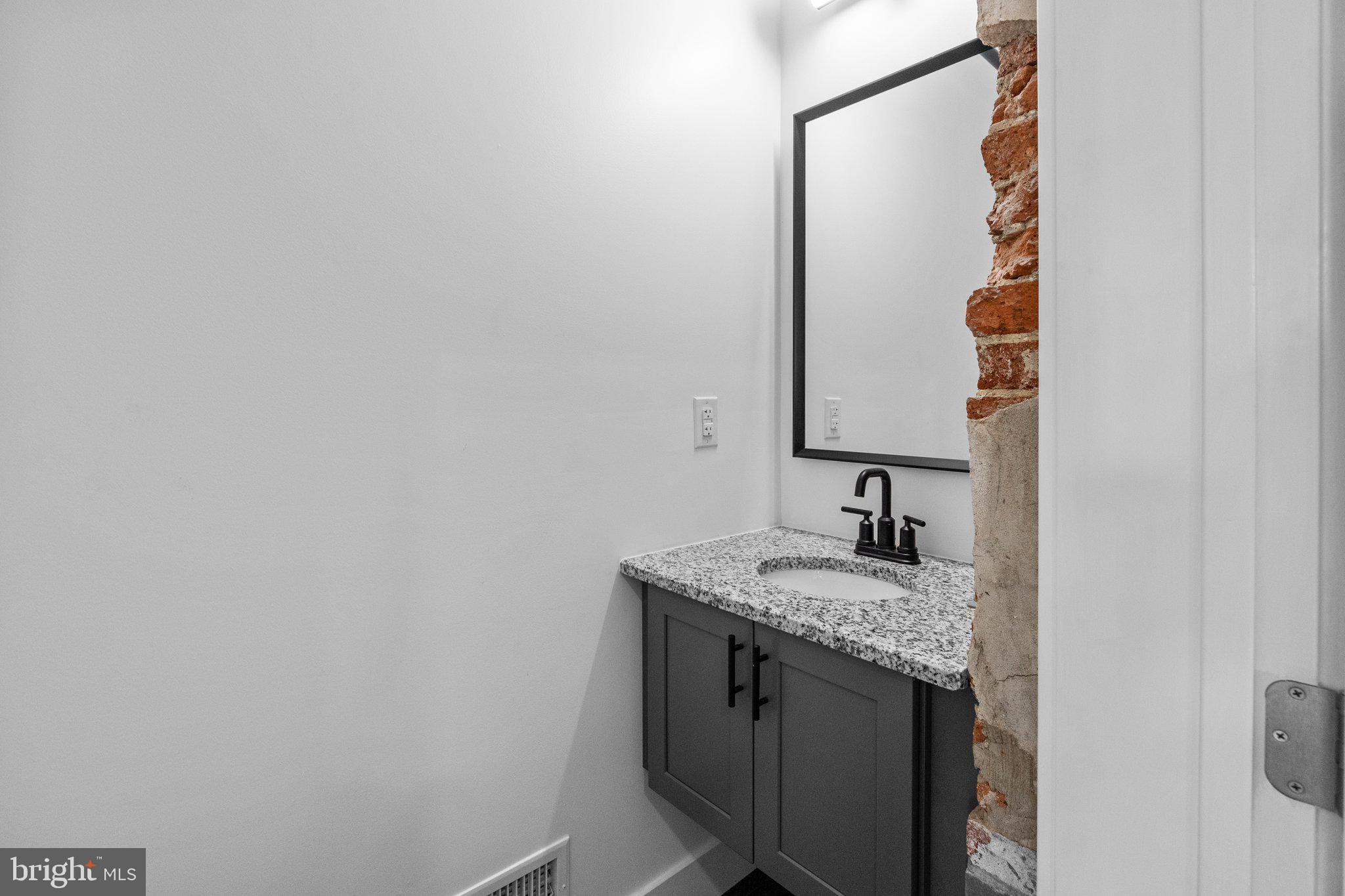 819 Blooming Glen Road, Unit 4 Perkasie, PA 18944 - Photo 11 of 21 a bathroom with a granite countertop sink and a mirror