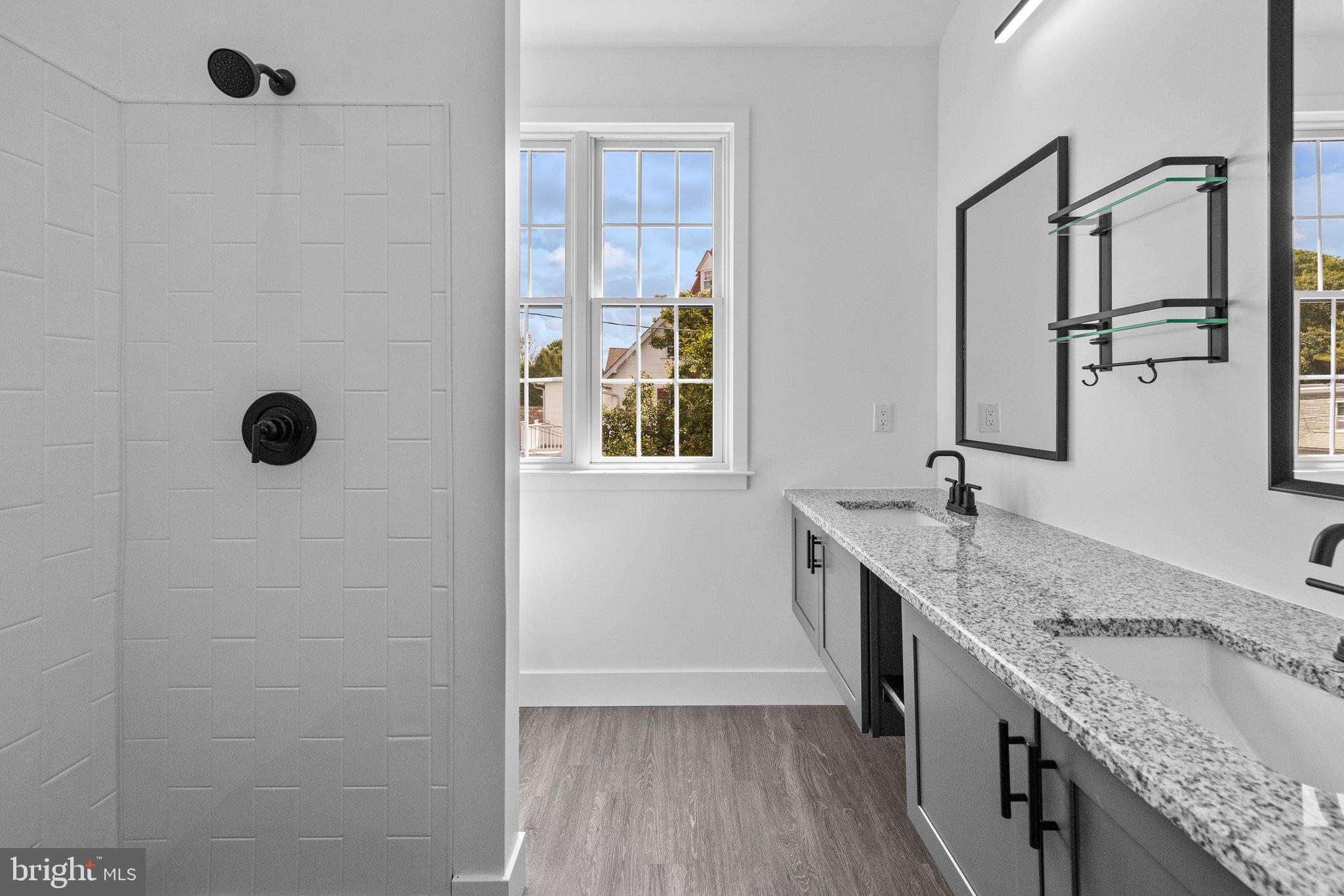 819 Blooming Glen Road, Unit 4 Perkasie, PA 18944 - Photo 16 of 21 a bathroom with a granite countertop sink a mirror and shower