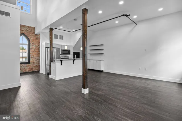 a view of a room with wooden floor and stairs
