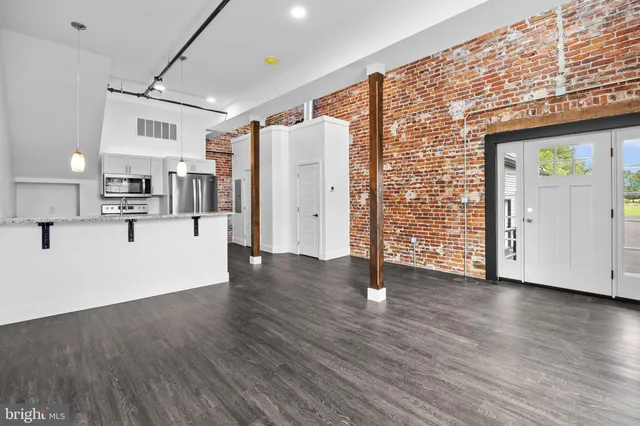 a view of a kitchen with wooden floor