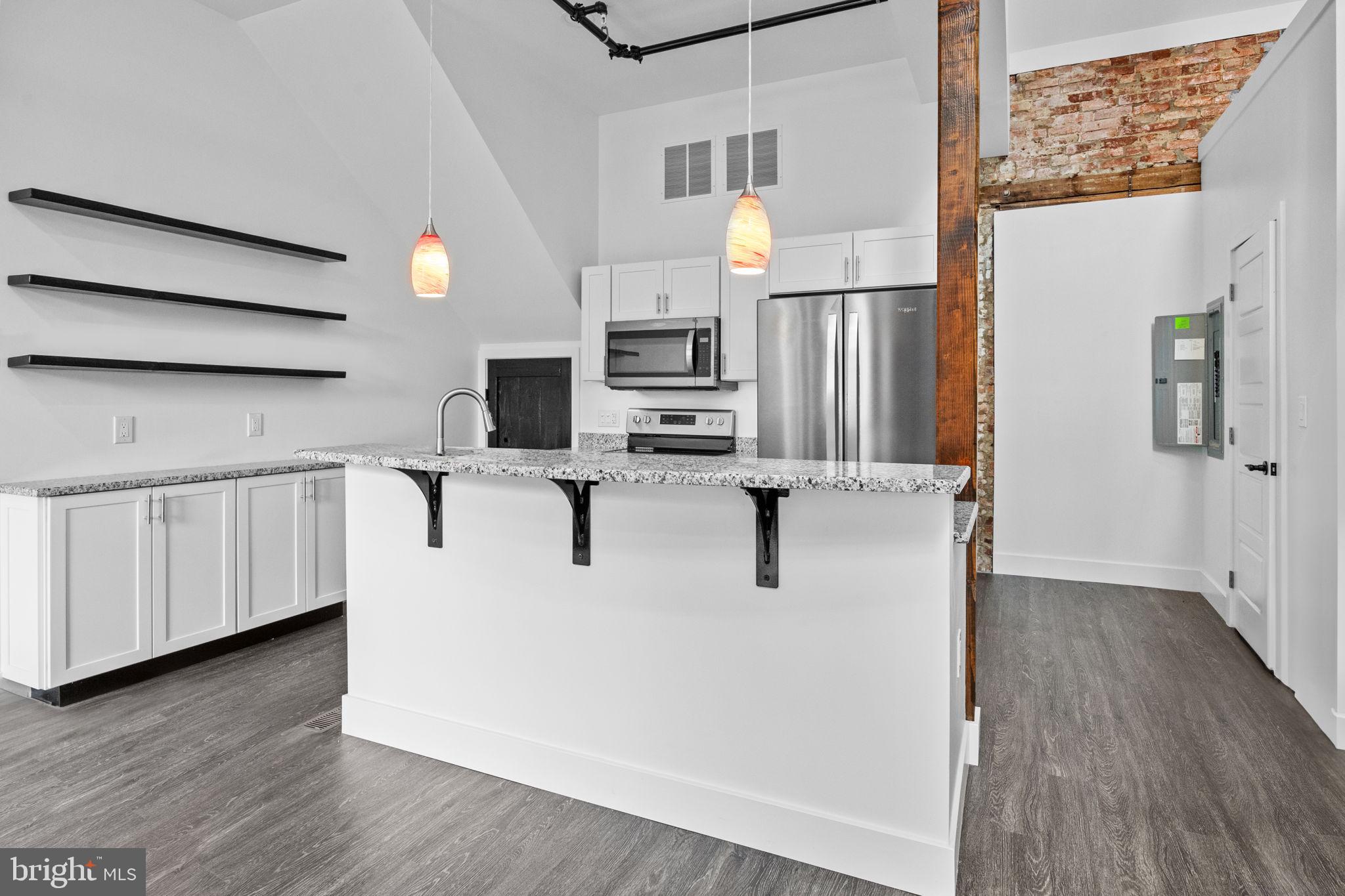 819 Blooming Glen Road, Unit 4 Perkasie, PA 18944 - Photo 8 of 21 a view of kitchen with stainless steel appliances granite countertop a refrigerator a stove a microwave and wooden floor