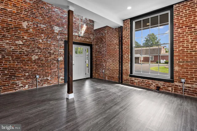 a view of a brick house with wooden floor and door