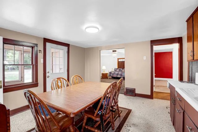 a view of a dining room with furniture and window