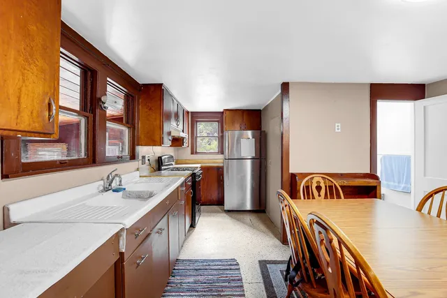 a kitchen that has a sink and a refrigerator