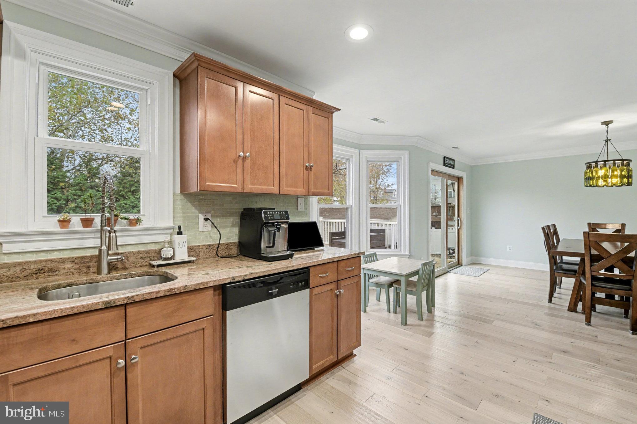 2804 7th Street Sparrows Point, MD 21219 - Photo 17 of 70 a kitchen with stainless steel appliances granite countertop white cabinets a sink and a stove