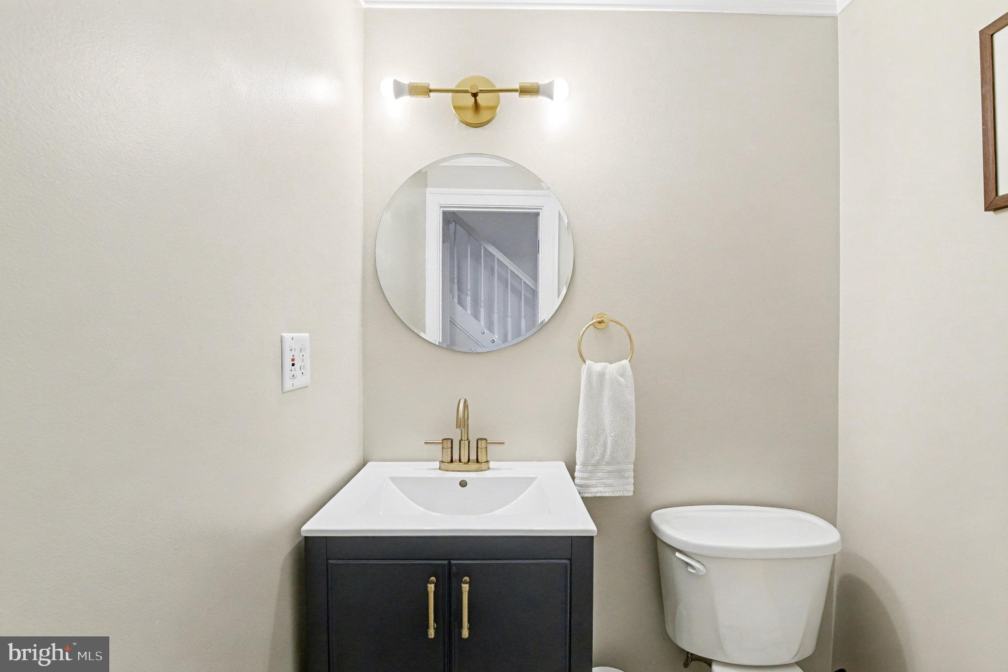 2804 7th Street Sparrows Point, MD 21219 - Photo 18 of 70 a bathroom with a toilet sink and mirror