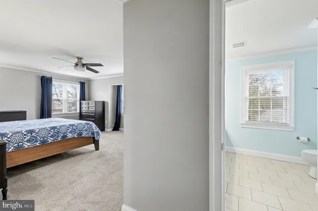 a spacious bathroom with a granite countertop sink mirror and a toilet