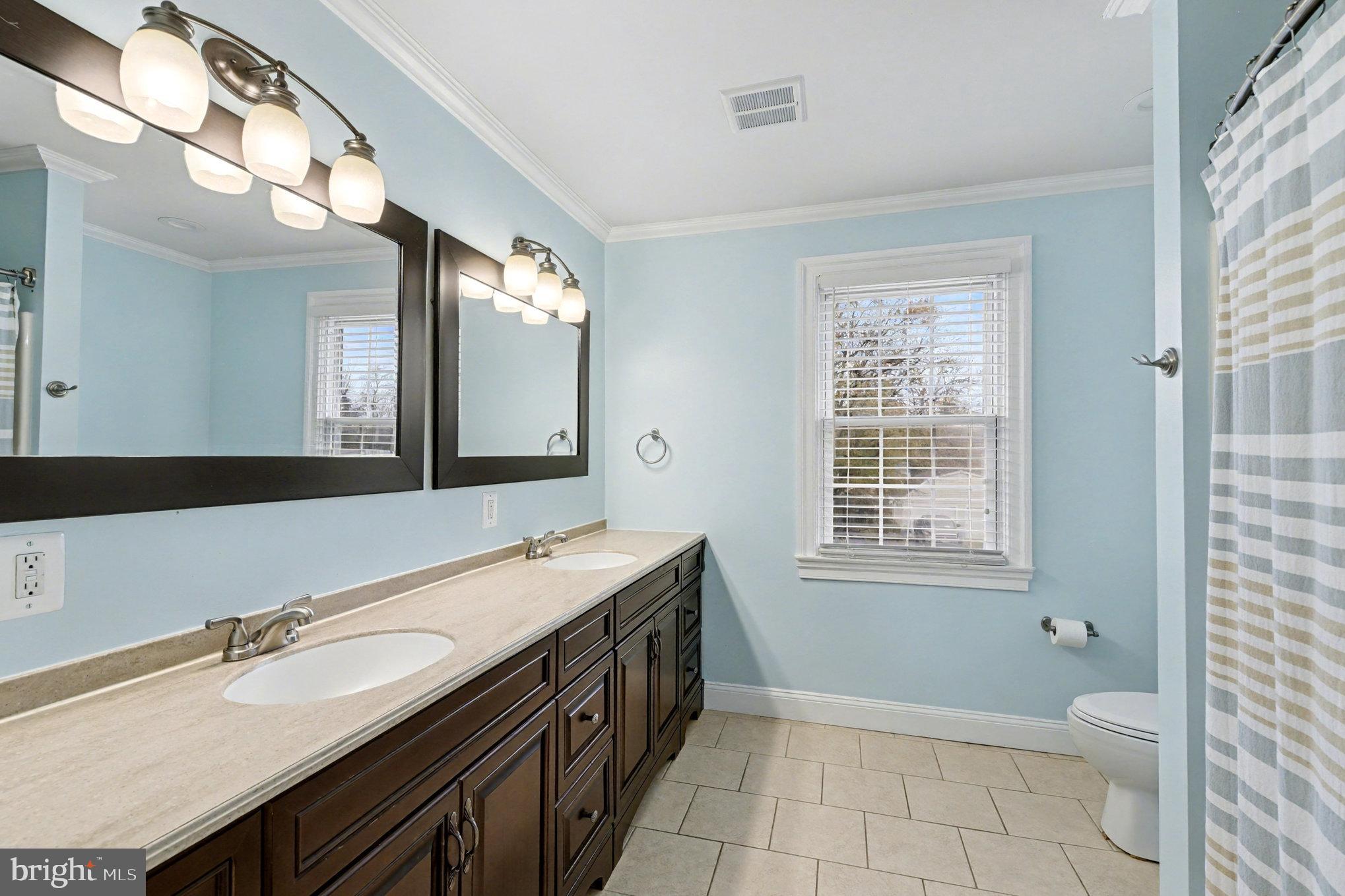 2804 7th Street Sparrows Point, MD 21219 - Photo 24 of 70 a spacious bathroom with a granite countertop sink mirror and a toilet