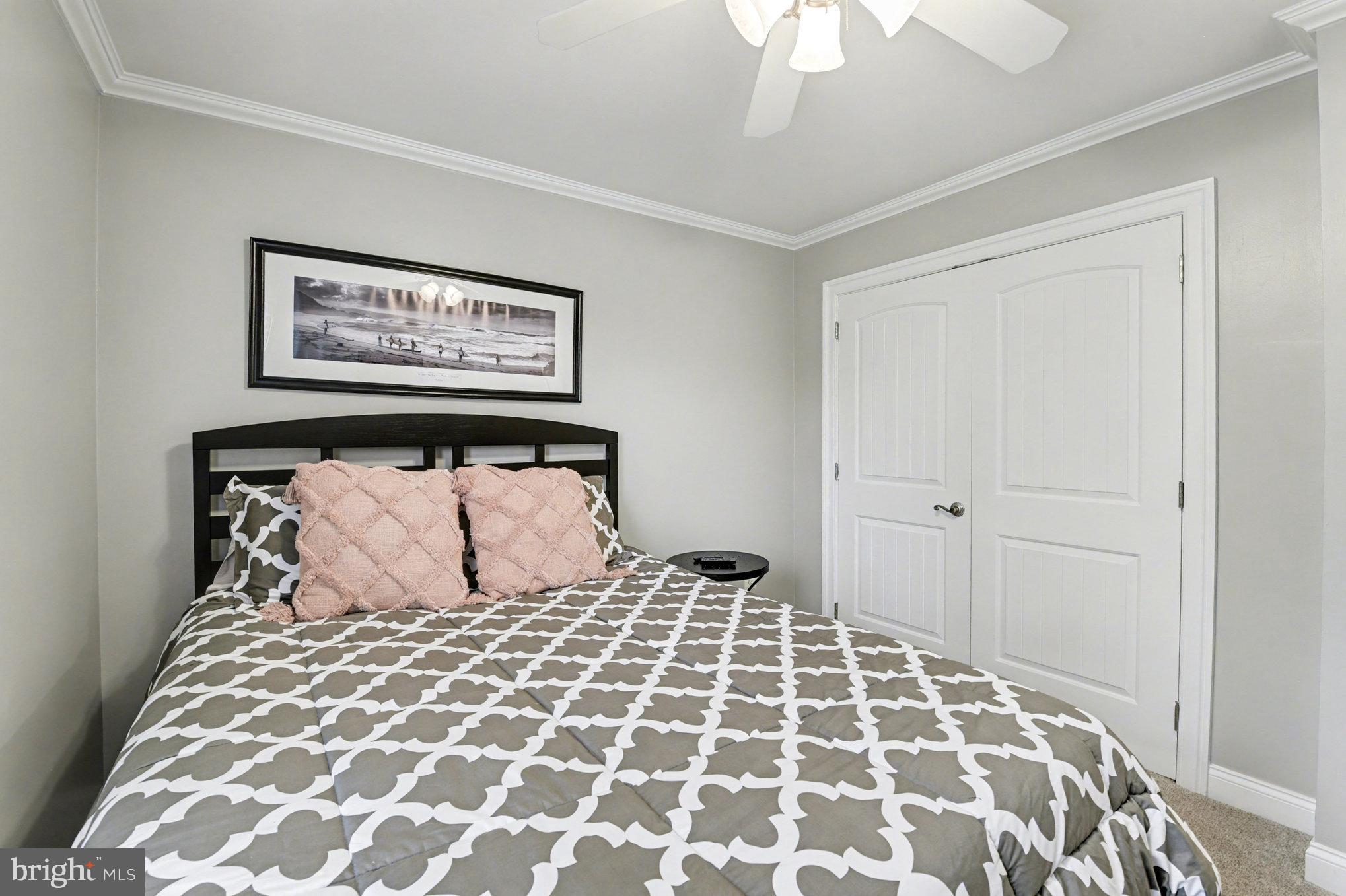 2804 7th Street Sparrows Point, MD 21219 - Photo 26 of 70 a bedroom with a large bed and a chandelier