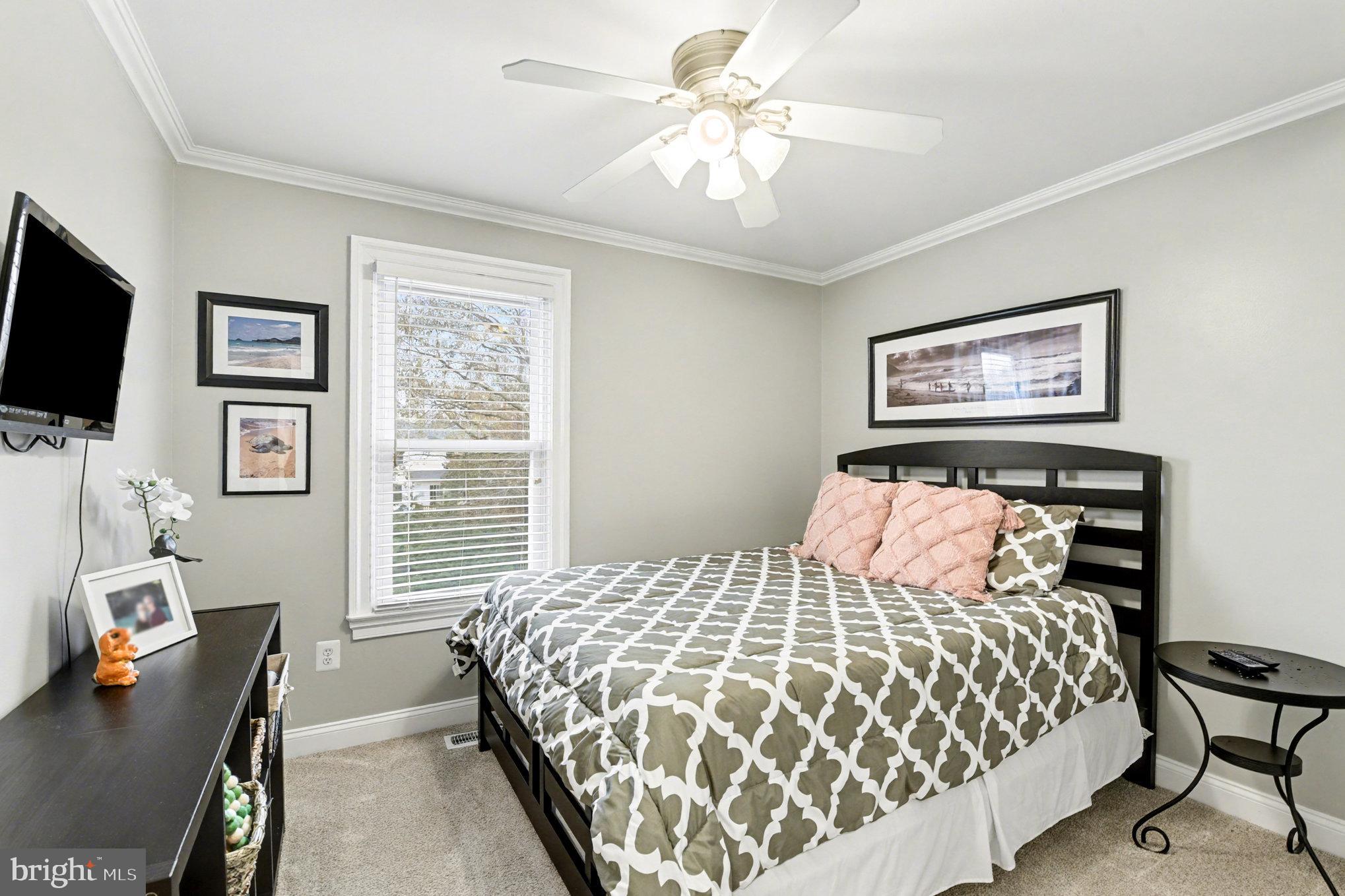2804 7th Street Sparrows Point, MD 21219 - Photo 27 of 70 a bedroom with a bed and a flat screen tv