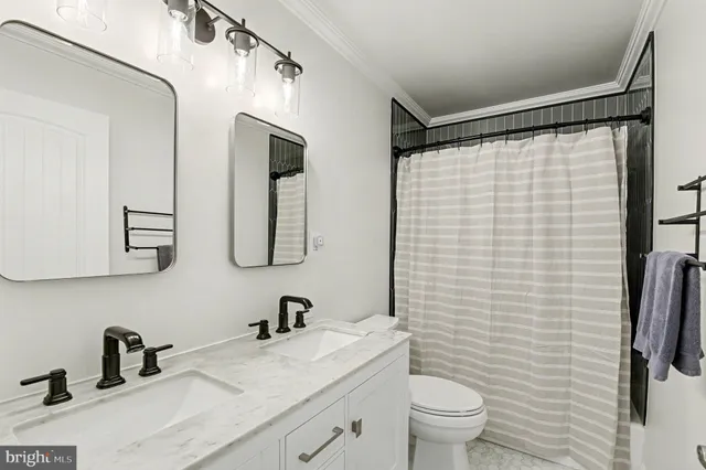 a bedroom with baby bed and a window