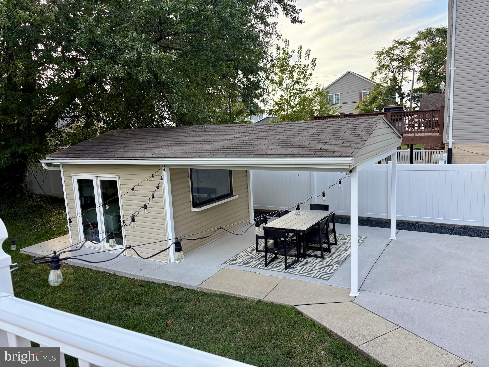 2804 7th Street Sparrows Point, MD 21219 - Photo 34 of 70 a view of a patio with table and chairs with wooden fence and plants