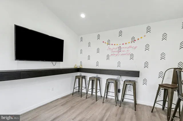 a view of a room with furniture wooden floor and window