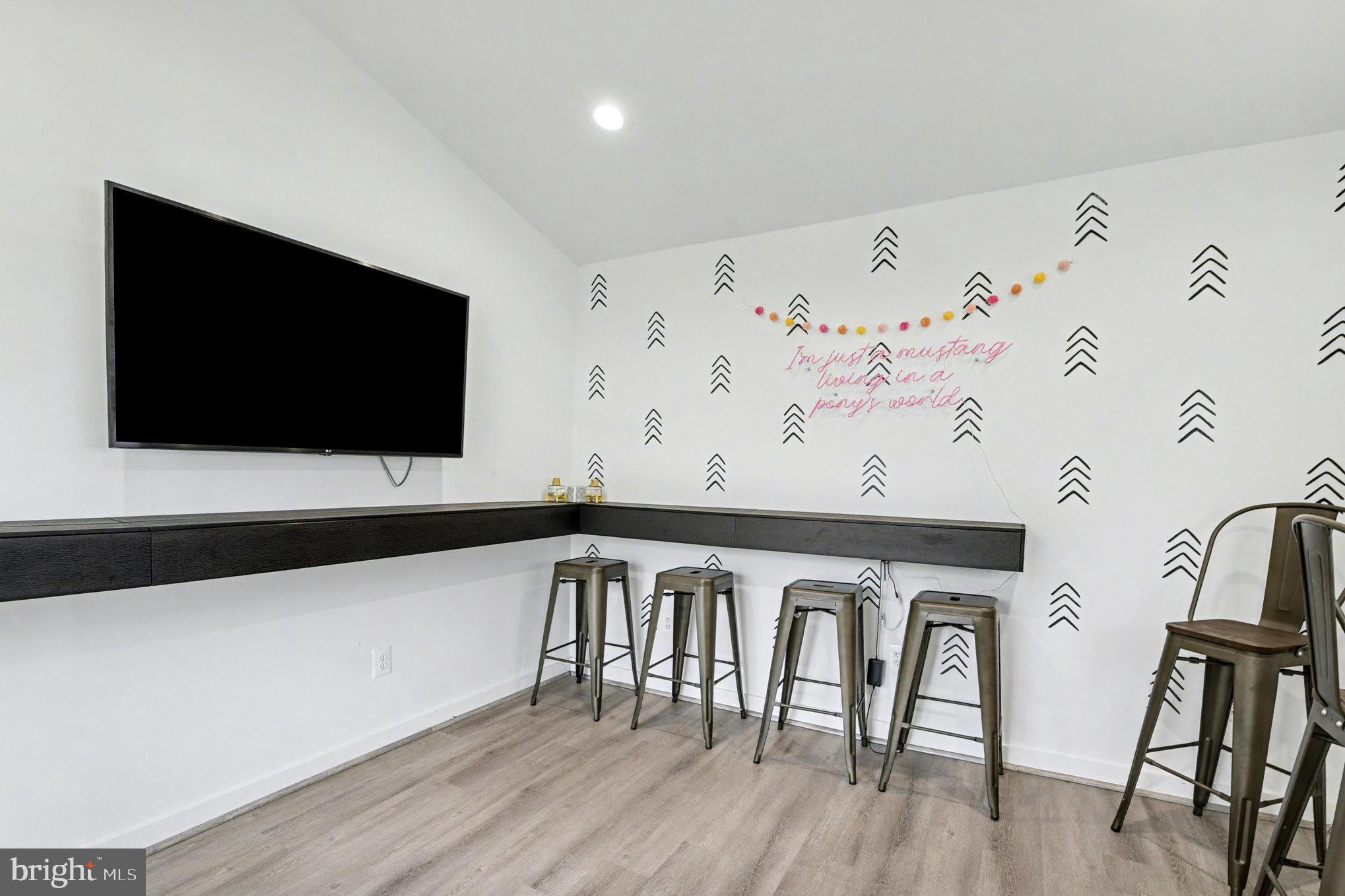 2804 7th Street Sparrows Point, MD 21219 - Photo 35 of 70 a view of a flat screen tv with wooden floor