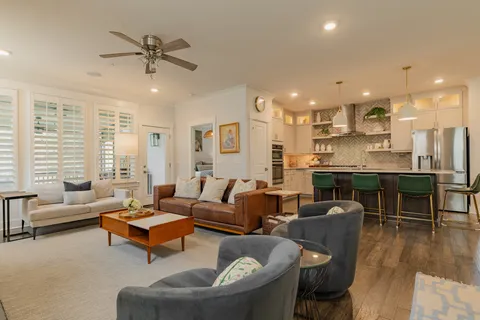a living room with furniture and kitchen view