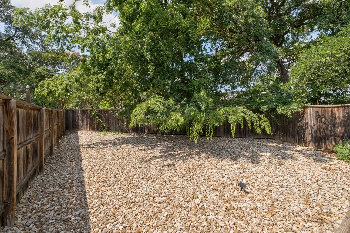 4008 Valley View Road, Unit B Austin, TX 78704 - Photo 20 of 21 a view of a backyard with large trees and wooden fence