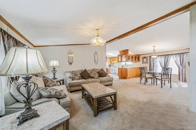 a living room with furniture a window and a flat screen tv
