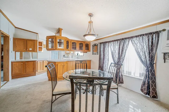 a view of a dining room with furniture and window