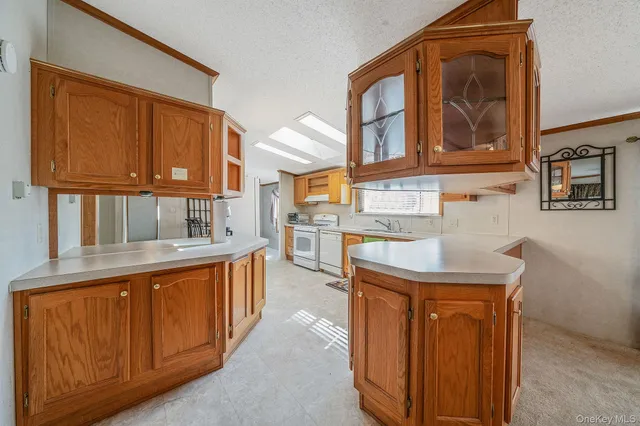 a kitchen that has a sink and a wooden cabinets