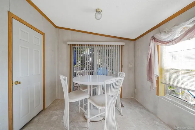 a view of a dining room with furniture and a window
