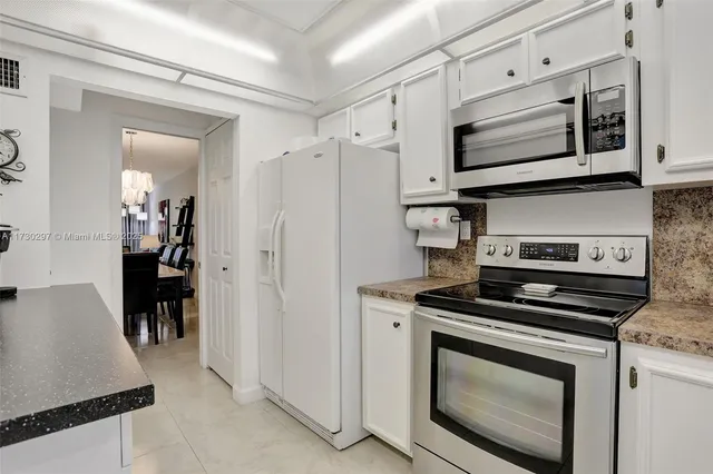 a kitchen with stainless steel appliances a stove a microwave and cabinets