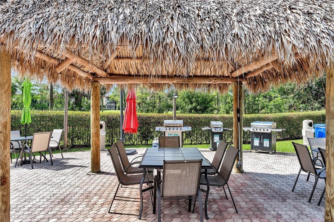 6080 Northwest 44th Street, Unit 212 Lauderhill, FL 33319 - Photo 34 of 44 a view of a patio with a table chairs and backyard