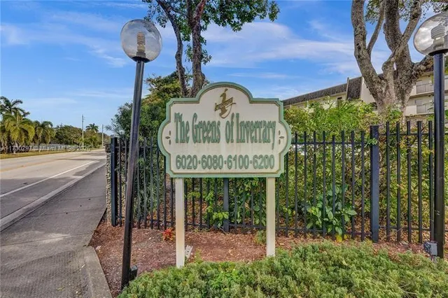 a front view of a building with parking space and a parking space