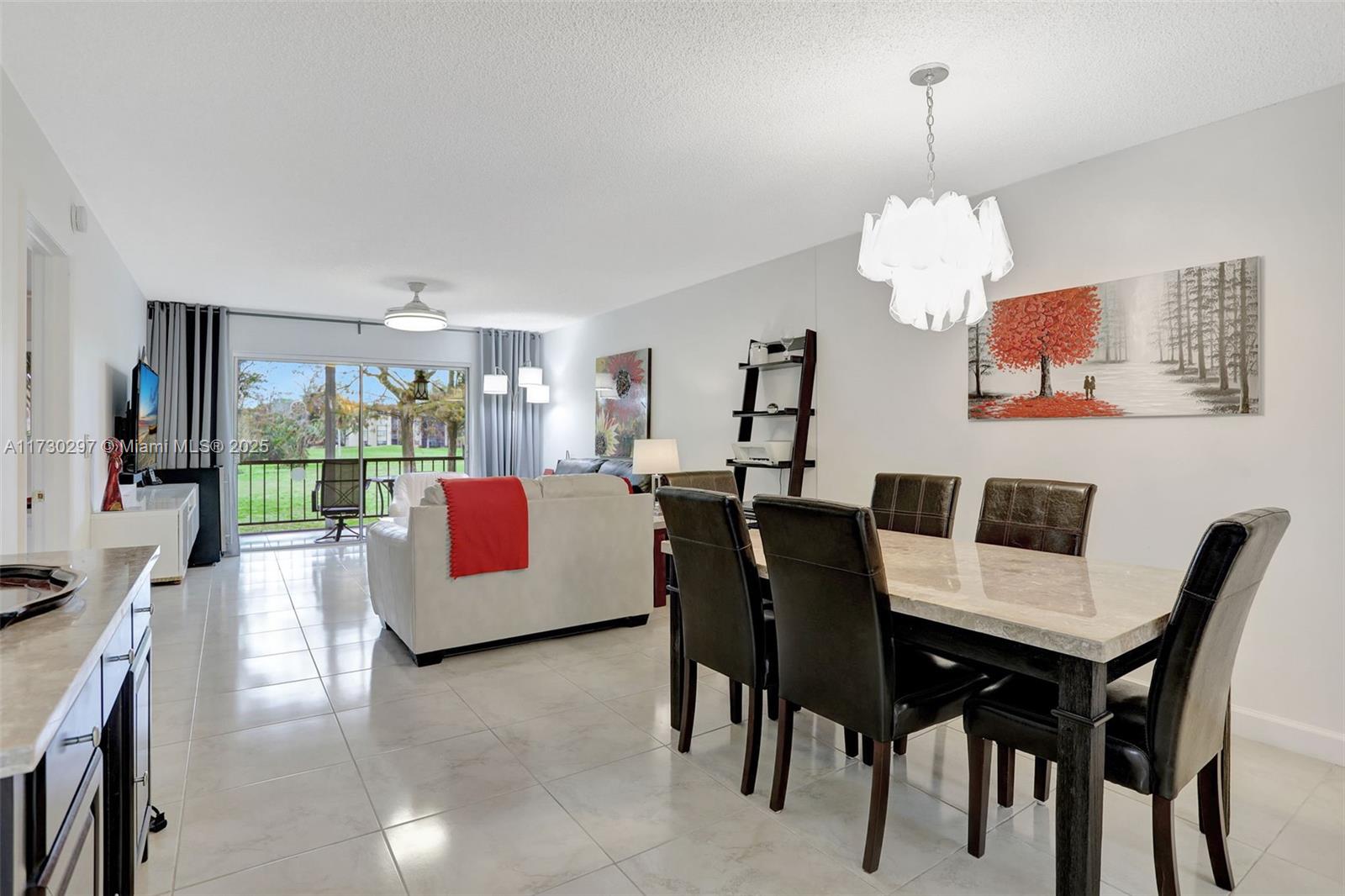 6080 Northwest 44th Street, Unit 212 Lauderhill, FL 33319 - Photo 6 of 44 a view of a dining room with furniture wooden floor and chandelier
