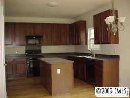 728 Baucom Road Monroe, NC 28110 - Photo 3 of 6 a kitchen with a stove and a refrigerator