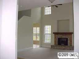 728 Baucom Road Monroe, NC 28110 - Photo 4 of 6 a view of an empty room with a fireplace