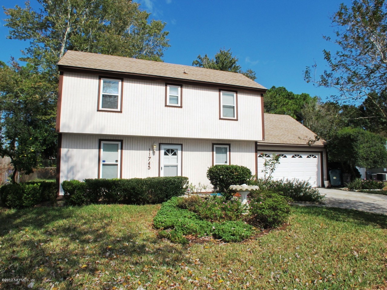 11745 Wattle Tree Road North Jacksonville, FL 32246 - Photo 1 of 18 a front view of a house with a yard and garage