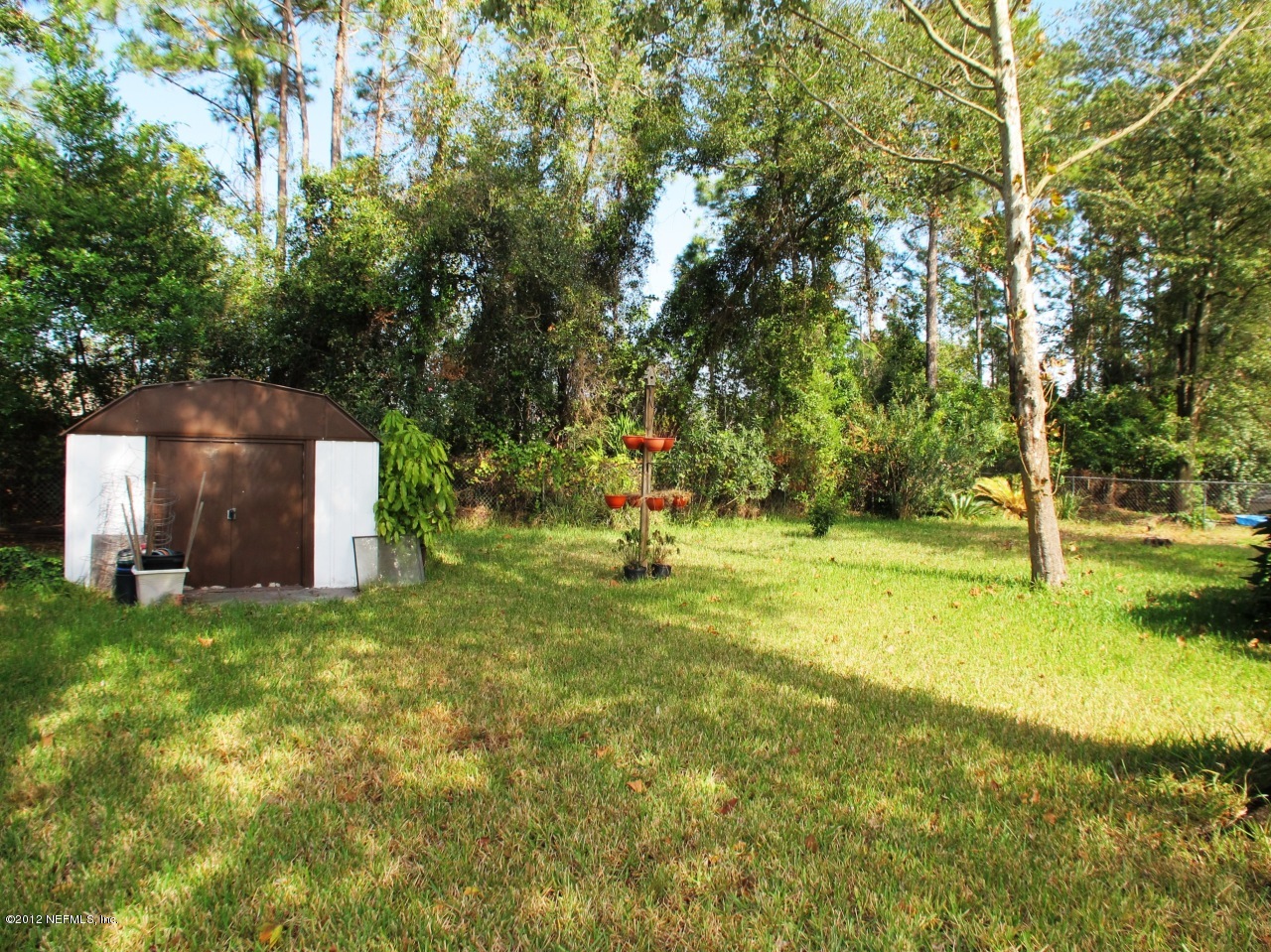 11745 Wattle Tree Road North Jacksonville, FL 32246 - Photo 16 of 18 a view of a yard with a house
