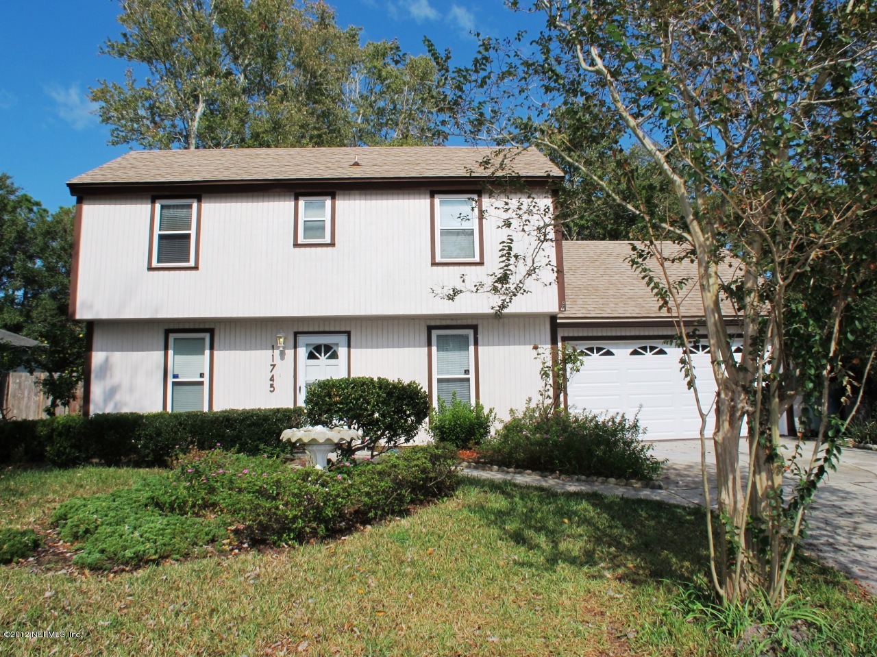 11745 Wattle Tree Road North Jacksonville, FL 32246 - Photo 2 of 18 a front view of a house with garden