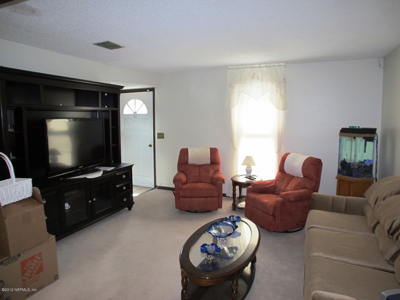 11745 Wattle Tree Road North Jacksonville, FL 32246 - Photo 4 of 18 a living room with furniture and a flat screen tv