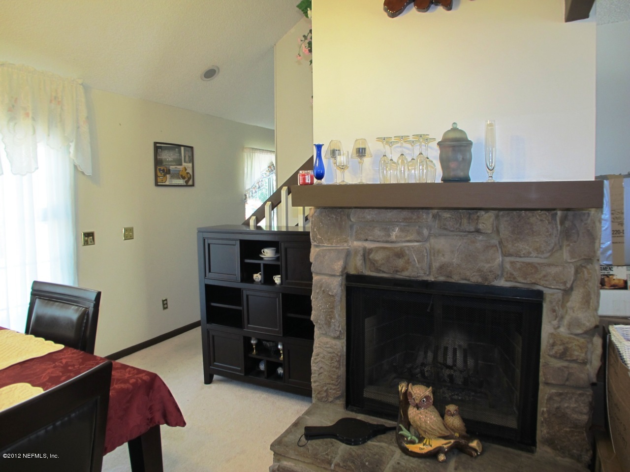 11745 Wattle Tree Road North Jacksonville, FL 32246 - Photo 5 of 18 a living room with furniture a flat screen tv and a fireplace