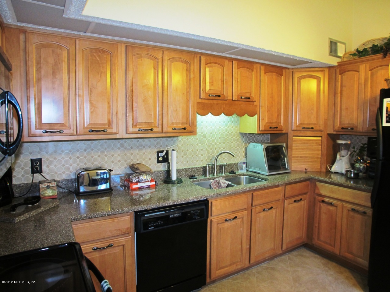 11745 Wattle Tree Road North Jacksonville, FL 32246 - Photo 7 of 18 a kitchen with stainless steel appliances granite countertop a sink a stove and cabinets