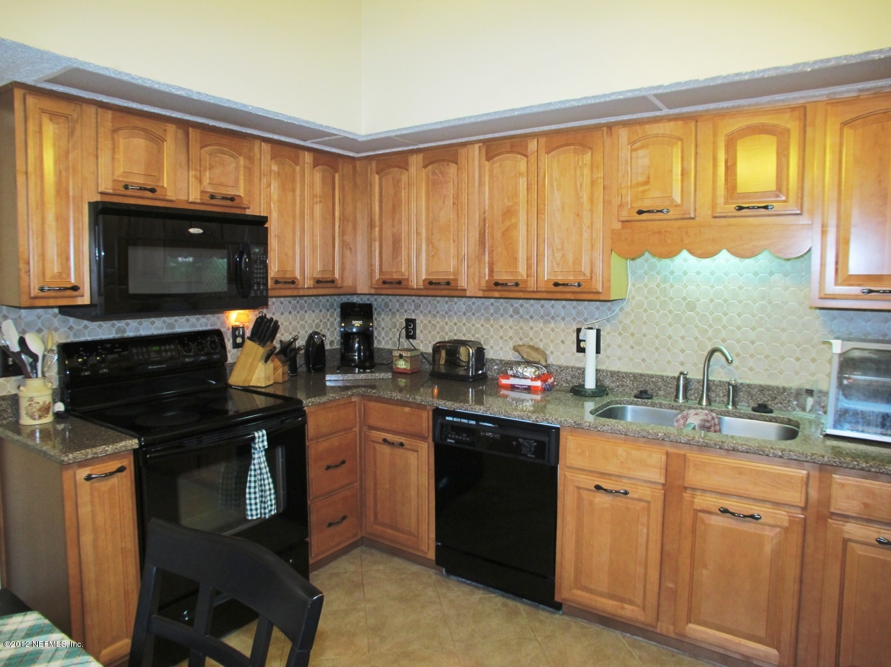 11745 Wattle Tree Road North Jacksonville, FL 32246 - Photo 8 of 18 a kitchen with a sink stove top oven and cabinets