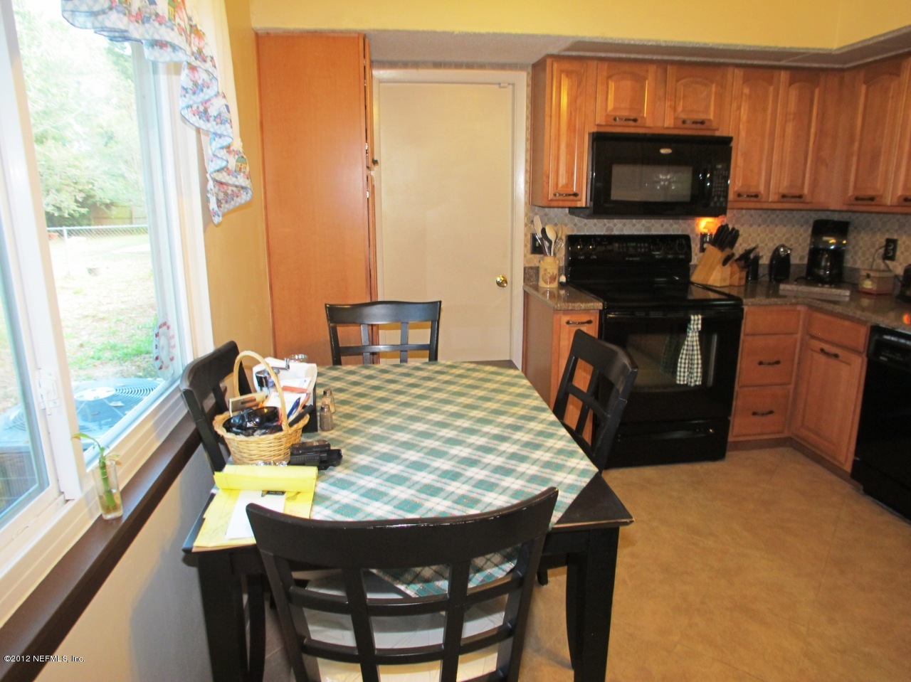 11745 Wattle Tree Road North Jacksonville, FL 32246 - Photo 9 of 18 a kitchen with a stove a sink and a refrigerator