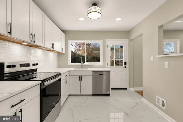 a kitchen that has a sink and a stove in it